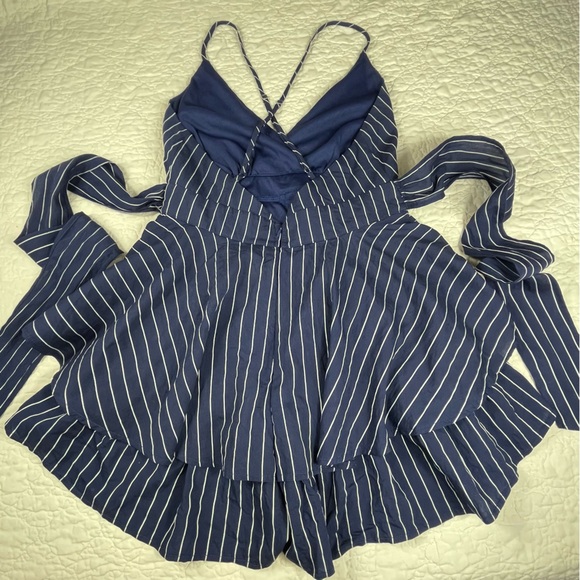 🔥Lulus Ruffle & Flow Black Striped Backless Ruffle
Romper Blue White - Picture 12 of 16